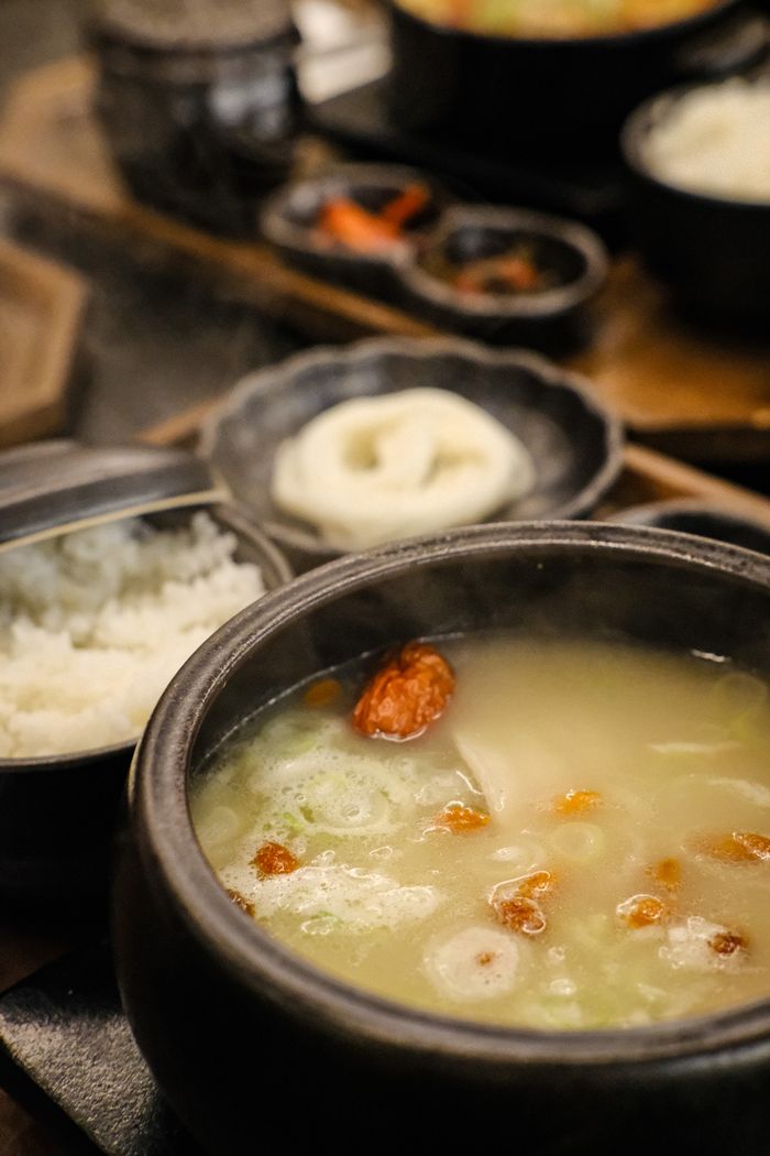 services-img Close-up of a steaming Korean hot pot with rice, showcasing a traditional meal.