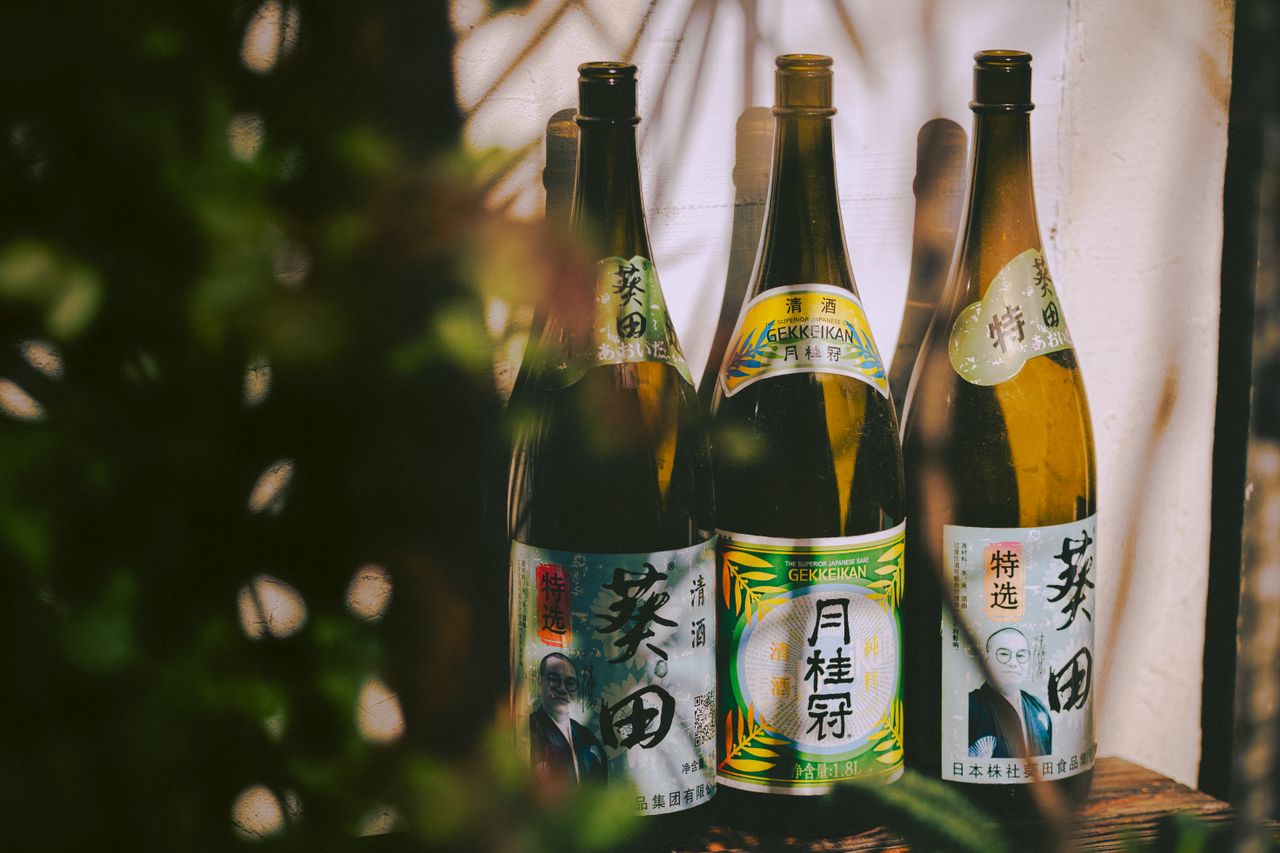 Crafting Captivating Headlines: Your awesome post title goes here Three traditional Japanese sake bottles with distinctive labels in a natural setting.